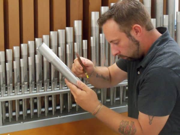 Technician, Sean Estanek tuning pipes at Leek Pipe Organ Company, Berea, OH