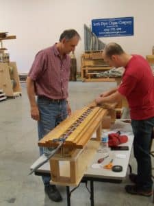 Organ Builder, James Leek and Technician, Owen Rasmussen doing a quality check of rewired magnets at Leek Pipe Organ Company workshop in Berea, Ohio