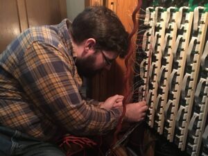 Technician Joe Raville wiring Solid State Planes on site at Holy Trinity Lutheran Church, Akron Ohio