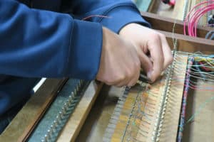 Leek staff wiring keyboards at shop in Berea, Ohio