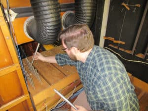 Technician Joseph Raville, inside the chambers reinstalling cleaned pipe work Hillgreen and Lane Pipe Organ, Barberton, Ohio