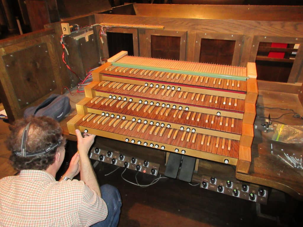 Sr. Technician John Jordon reinstalling restored keyboards on site at Holy Trinity Lutheran Church, Akron, Ohio