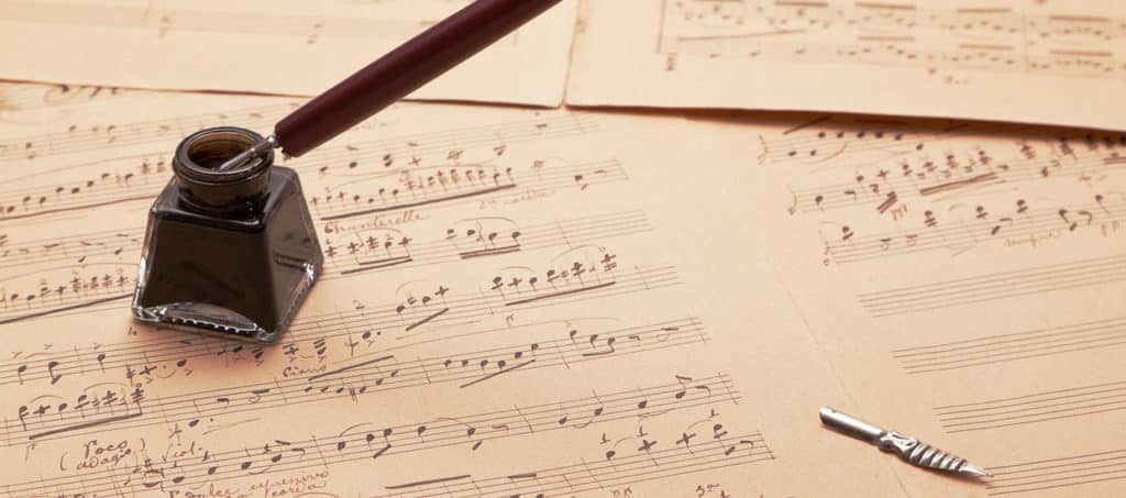 Musical score with quill pen, ink pot and quill pen nib