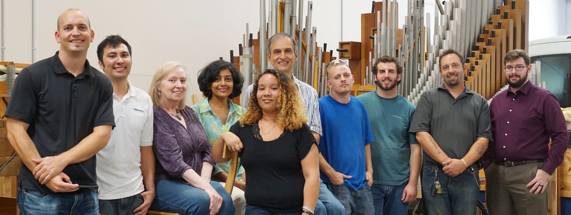 eek Pipe Organ Company Staff with backdrop of Schantz Pipe Organ, located at workshop in Berea, OH