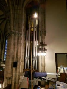 Leek Pipe Organ Company Technicians Reinstalling repaired Facade Principal 16' Pipes in Organ Chamber