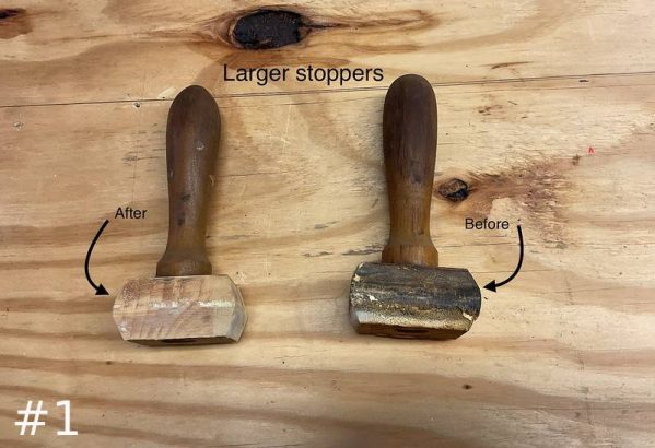 Two wooden organ pipe stoppers sit on a plywood surface labeled "Larger stoppers," with arrows pointing to a clean "After" unit on the left and a dirty "Before" unit on the right.
